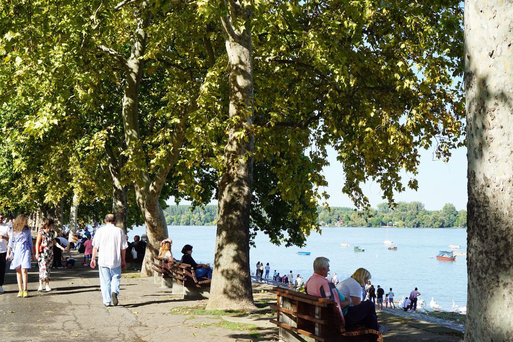 People sitting by the Danube River